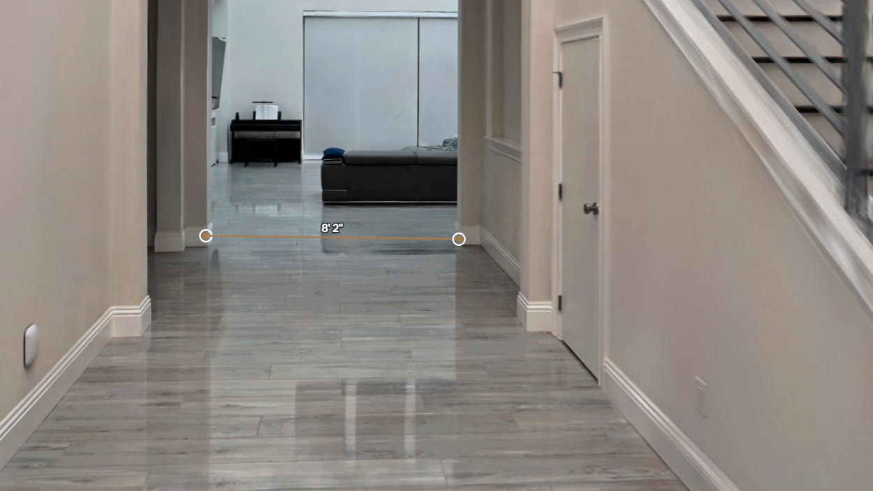 The Rendition tour viewer measuring a wall span with the tap-to-measure tool